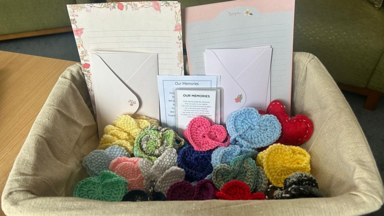 Crocheted hearts and memory envelopes in basket