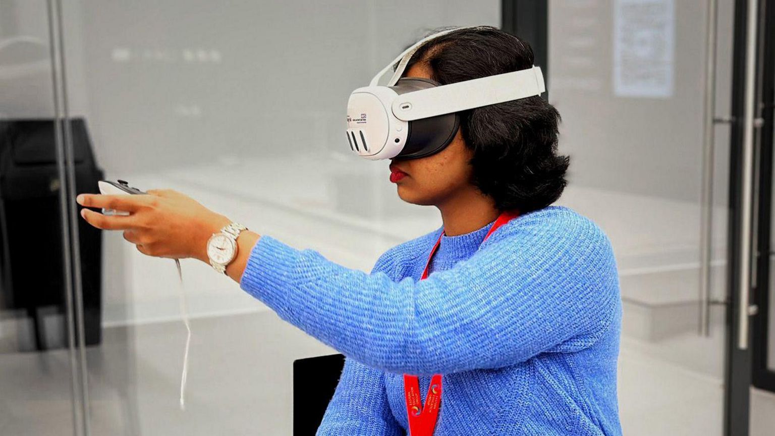 A woman with dark hair and a blue jumper uses the new VR headset