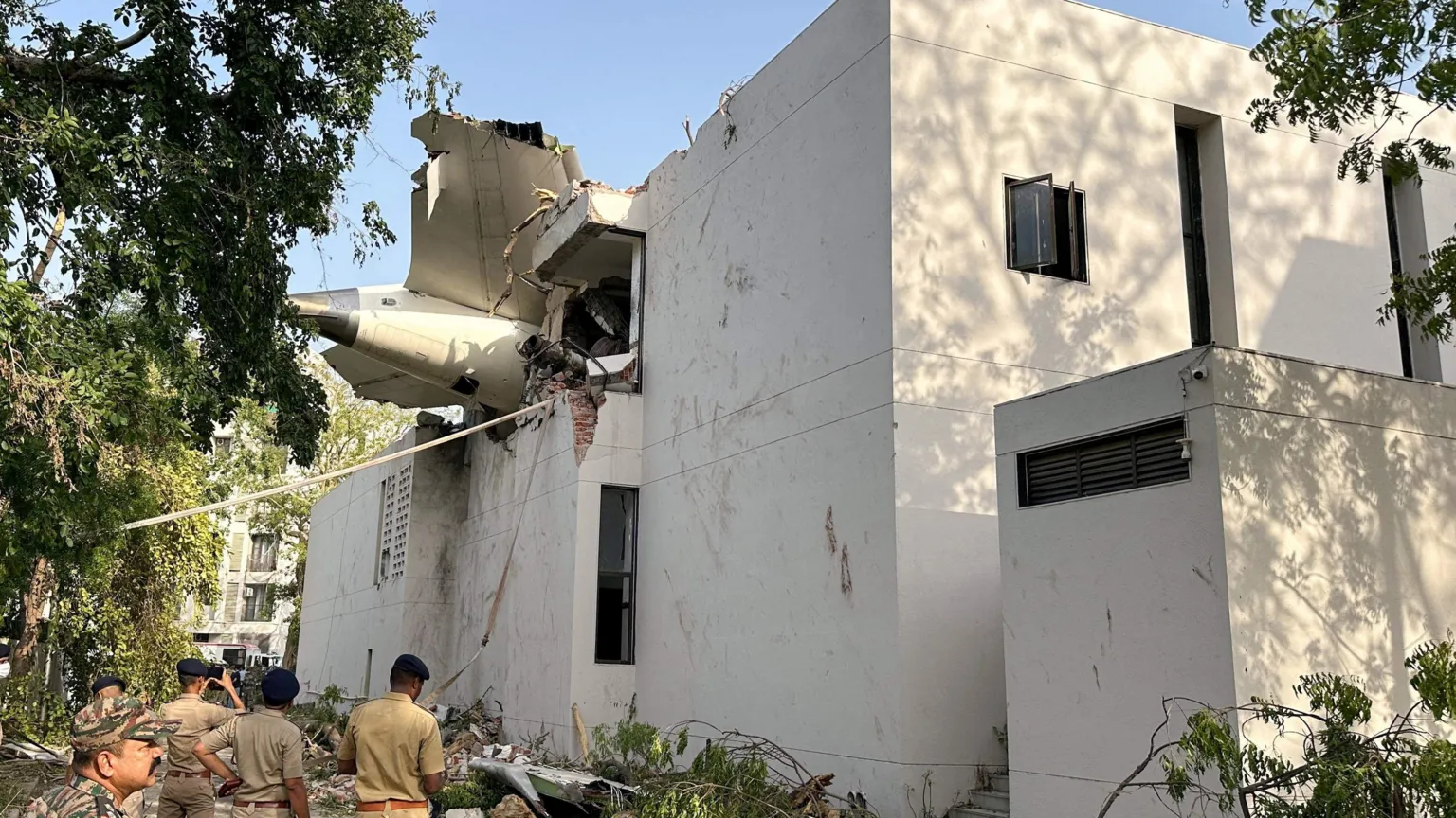 Reuters A tail of an Air India Boeing 787 Dreamliner plane that crashed is seen stuck on a building after the incident in Ahmedabad, India, June 12, 2025. REUTERS/Amit Dave