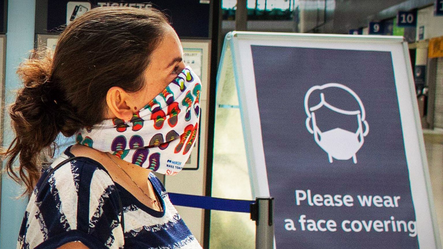 Woman at railway station wearing a face mask