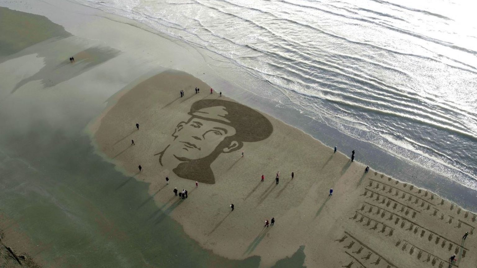 A portrait of John McCance, a soldier from County Down who died at Passchendaele, is drawn in the sand at Murlough Beach