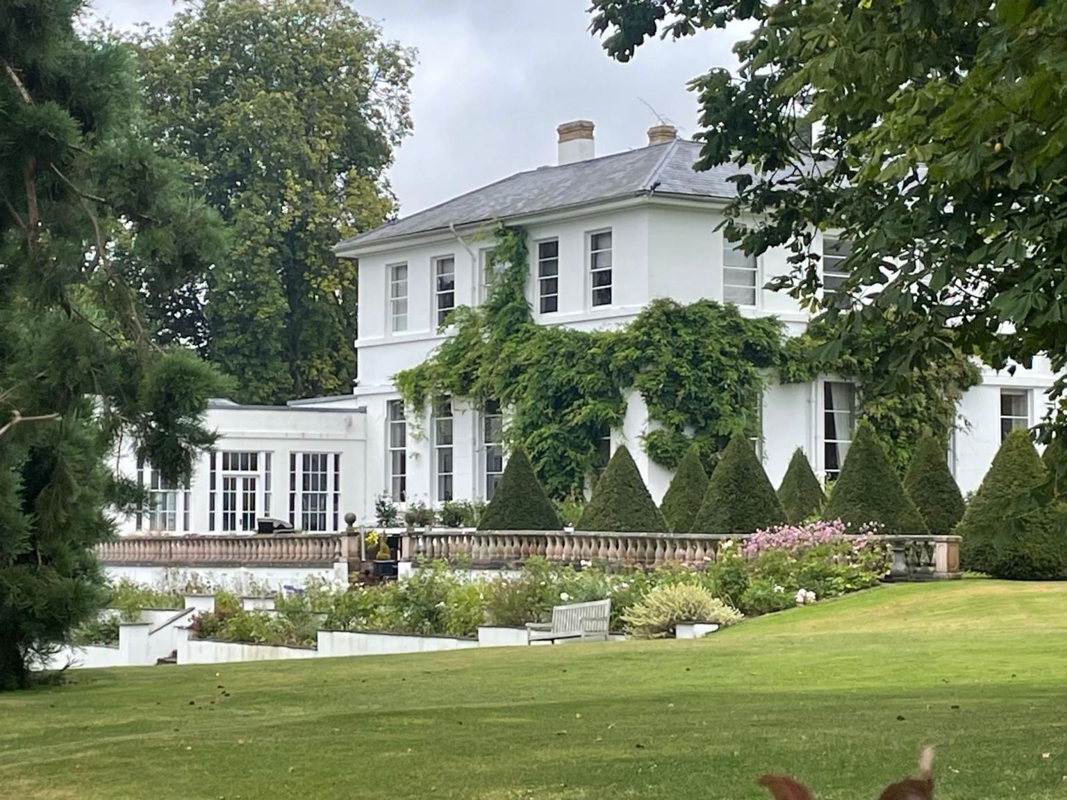 Large white house with landscaped garden