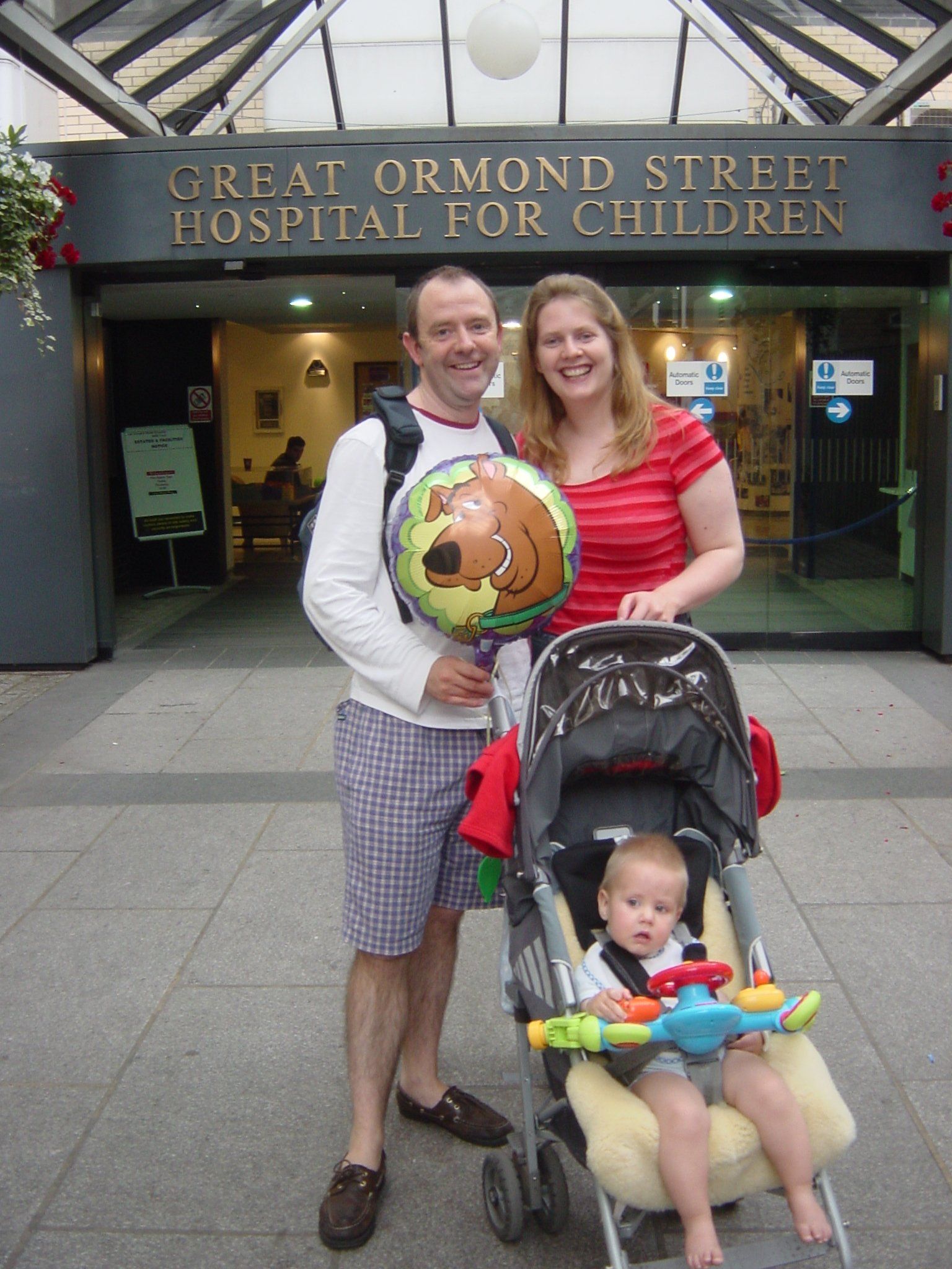 Ollie with his mum and dad outside hospital