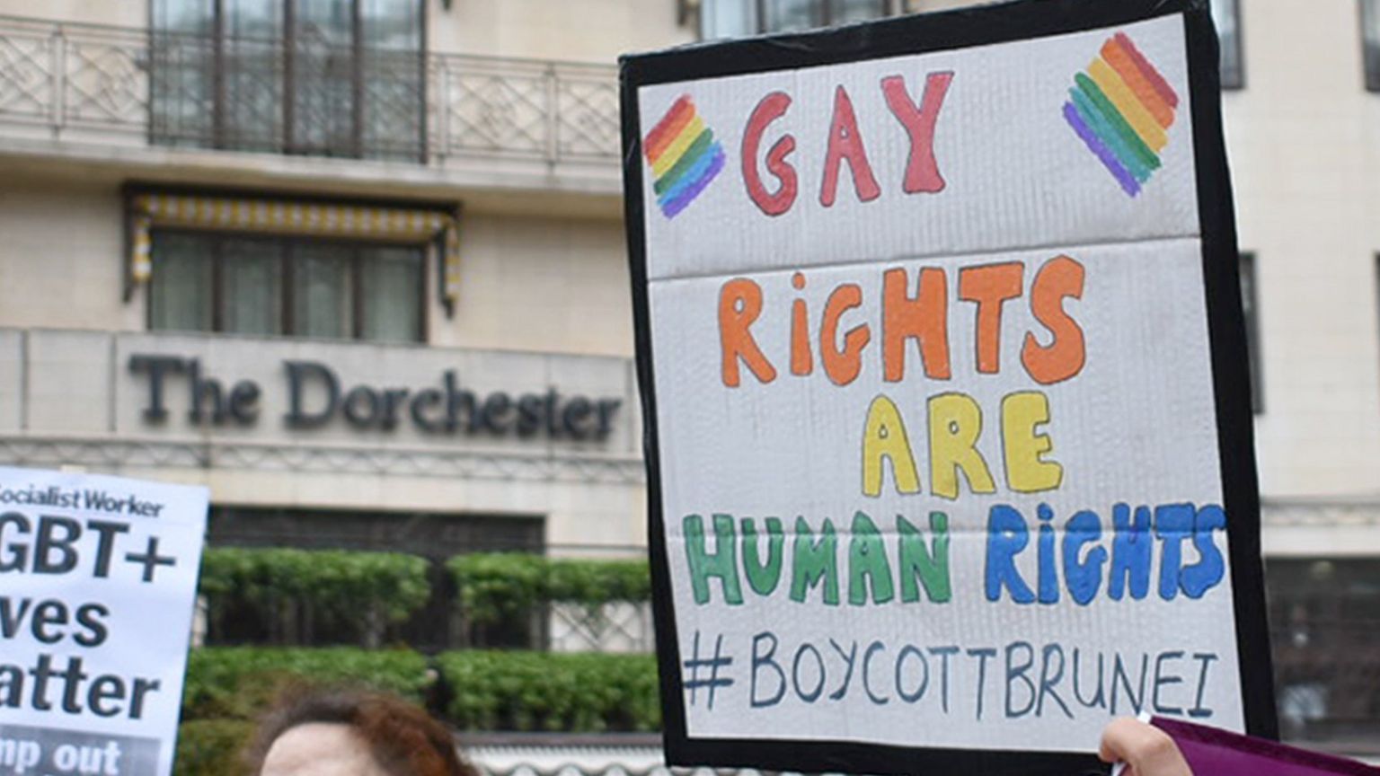 Protestors outside The Dorchester hotel on Park Lane, London
