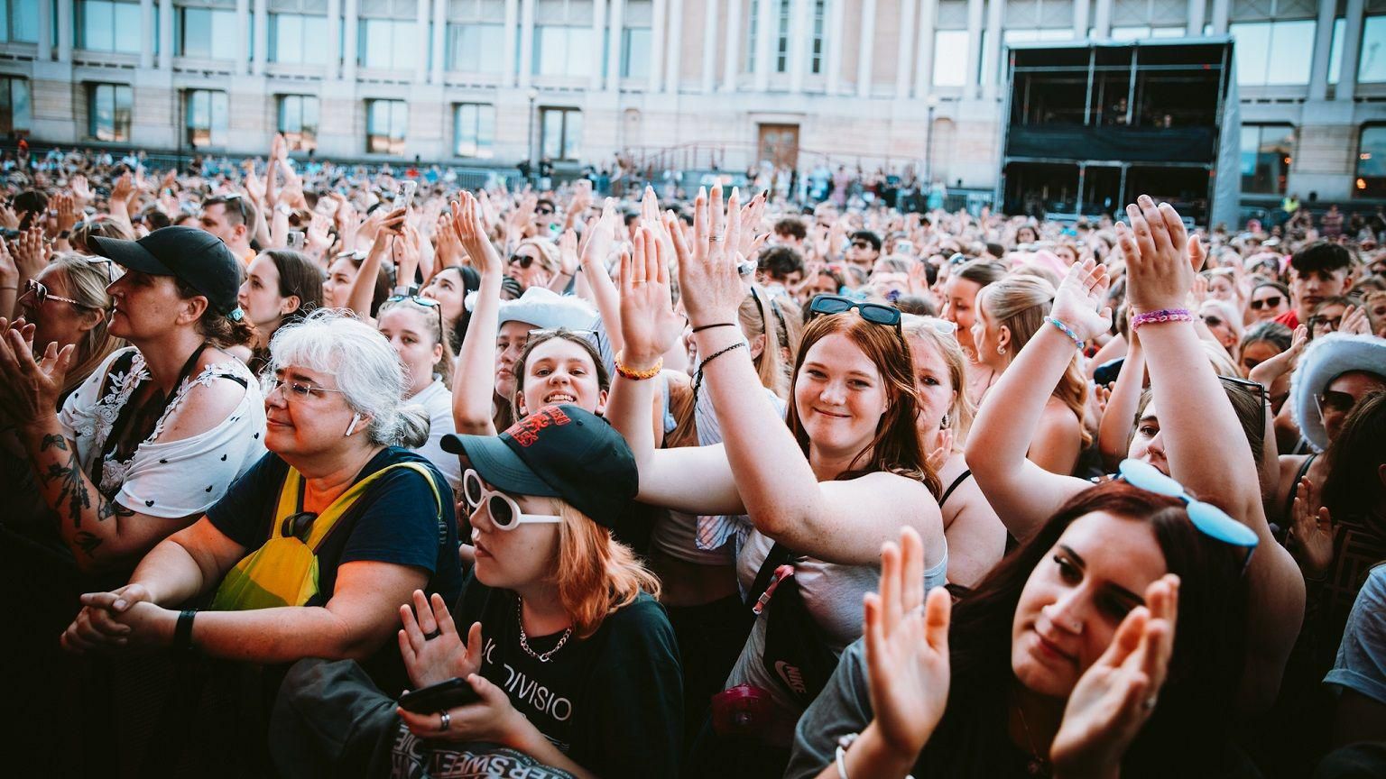 Fans on the front row of the James Arthur gig at Bristol Sounds 2024 smile at the camera