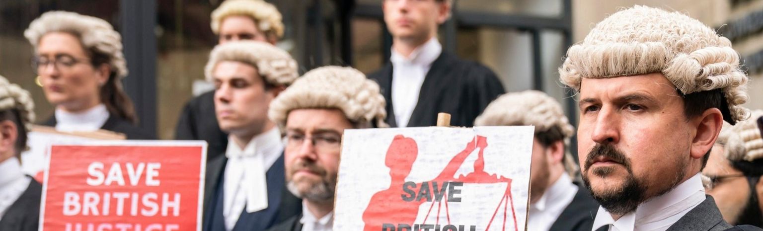 A group of lawyers in wigs picket outside Leeds Combined Court