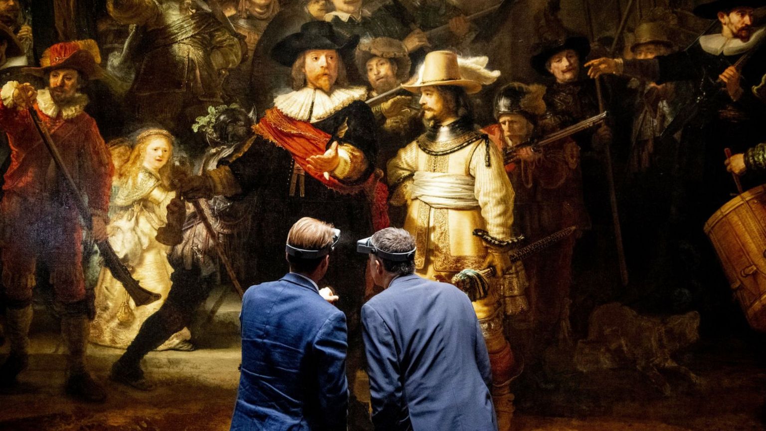 General director Taco Dibbits (L) of the Rijksmuseum and Thierry Vanlancker (CEO) of AkzoNobel stand in front of Rembrandt van Rijn's The Night Watch in Amsterdam