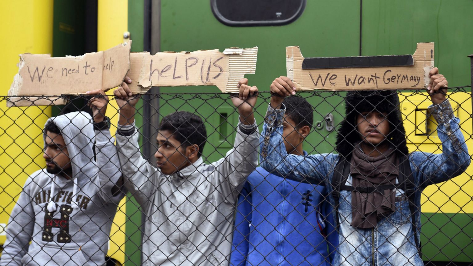 Migrants hold up signs at the Railway Station in Bicske, Hungary - 4 September 2015
