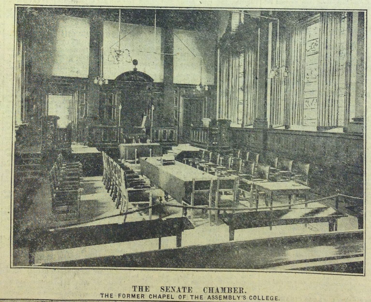 Black and White photograph of chairs around a long table in the college chapel