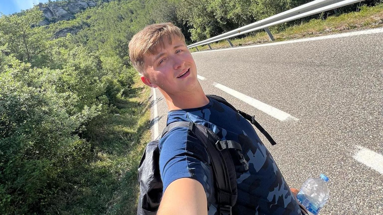 Henry Moores takes a selfie on a roadside during his journey.
