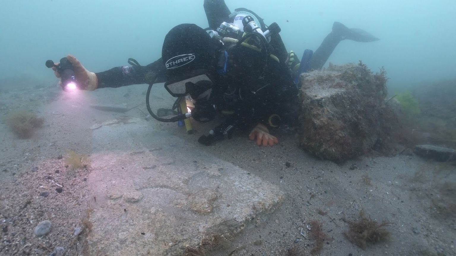 Diver inspecting the gravestone