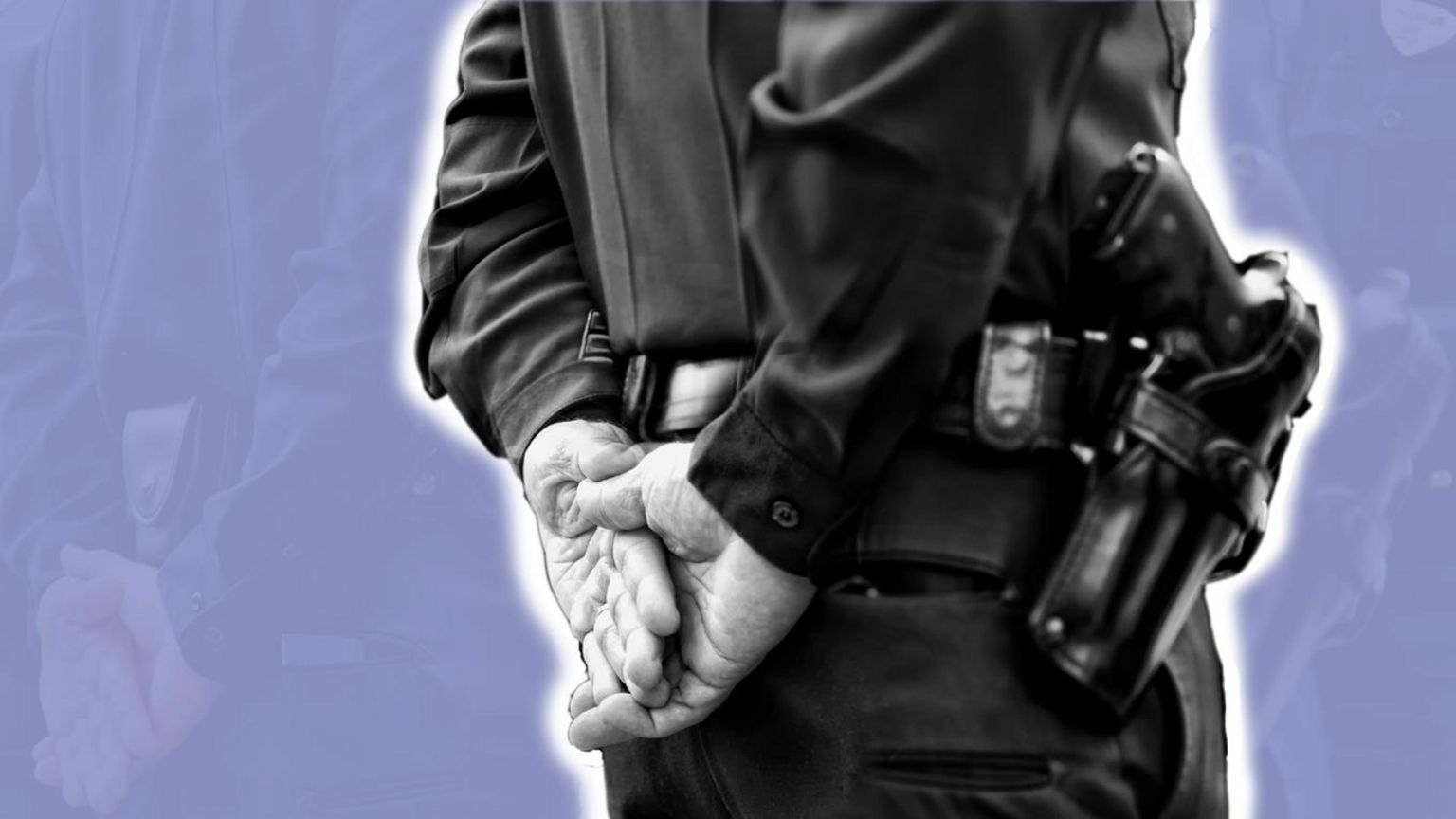 Police officer with hands clasped behind his back