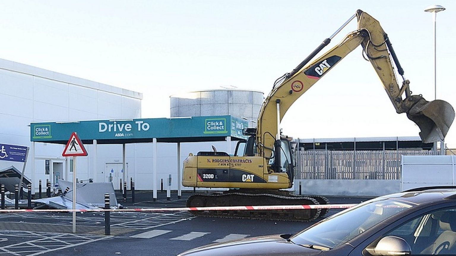 A large digger in the carpark of Asda in Antrim