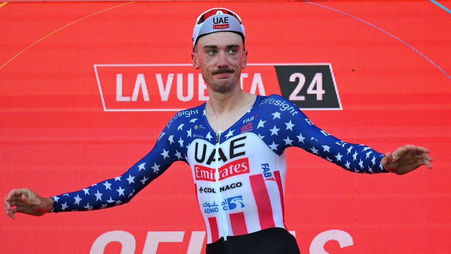 Brandon McNulty celebrates winning the opening stage on the podium