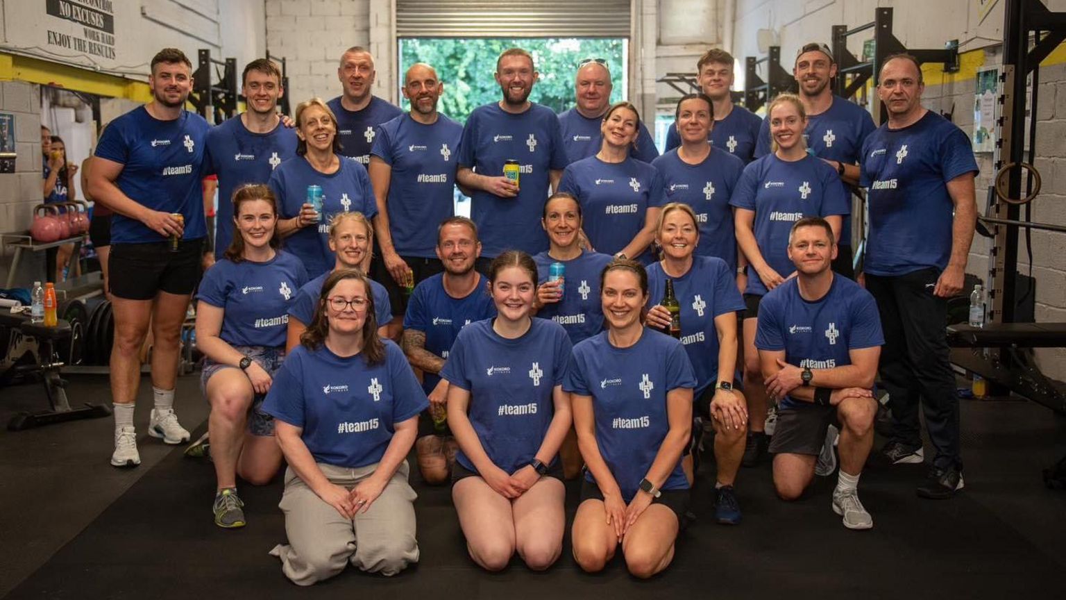 Image of a group of people at a gym all wearing the same blue T-shirt