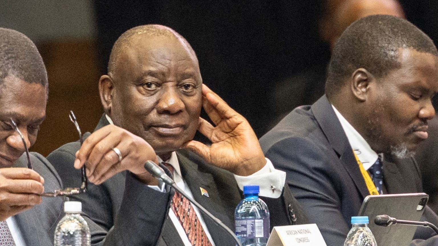 Deputy president of the African National Congress (ANC) Paul Mashatile (L) and president of the African National Congress (ANC) and South African President Cyril Ramaphosa (2nd L) attend the first sitting of the New South African Parliament in Cape Town on  14 June.