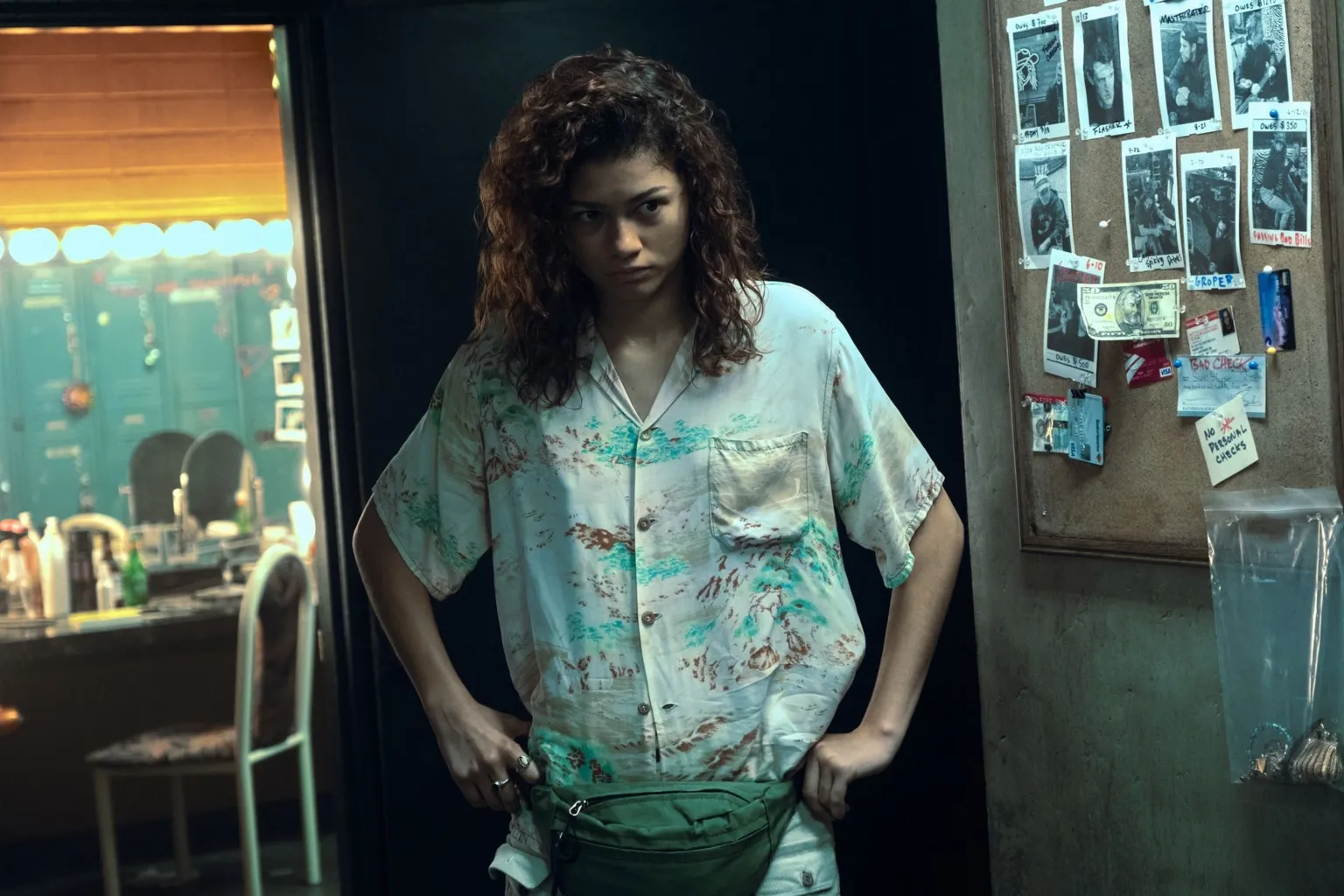 Eddy Chen/HBO Zendaya as Rue wearing a white shirt and hands on her hips