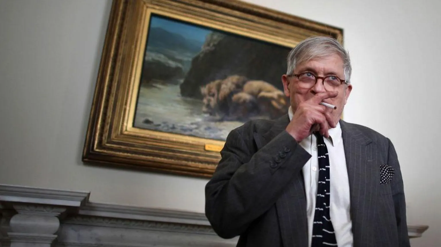 Getty Images David Hockney smoking in an art gallery in 2011.  He is standing in front of an old master painting while doing so.
