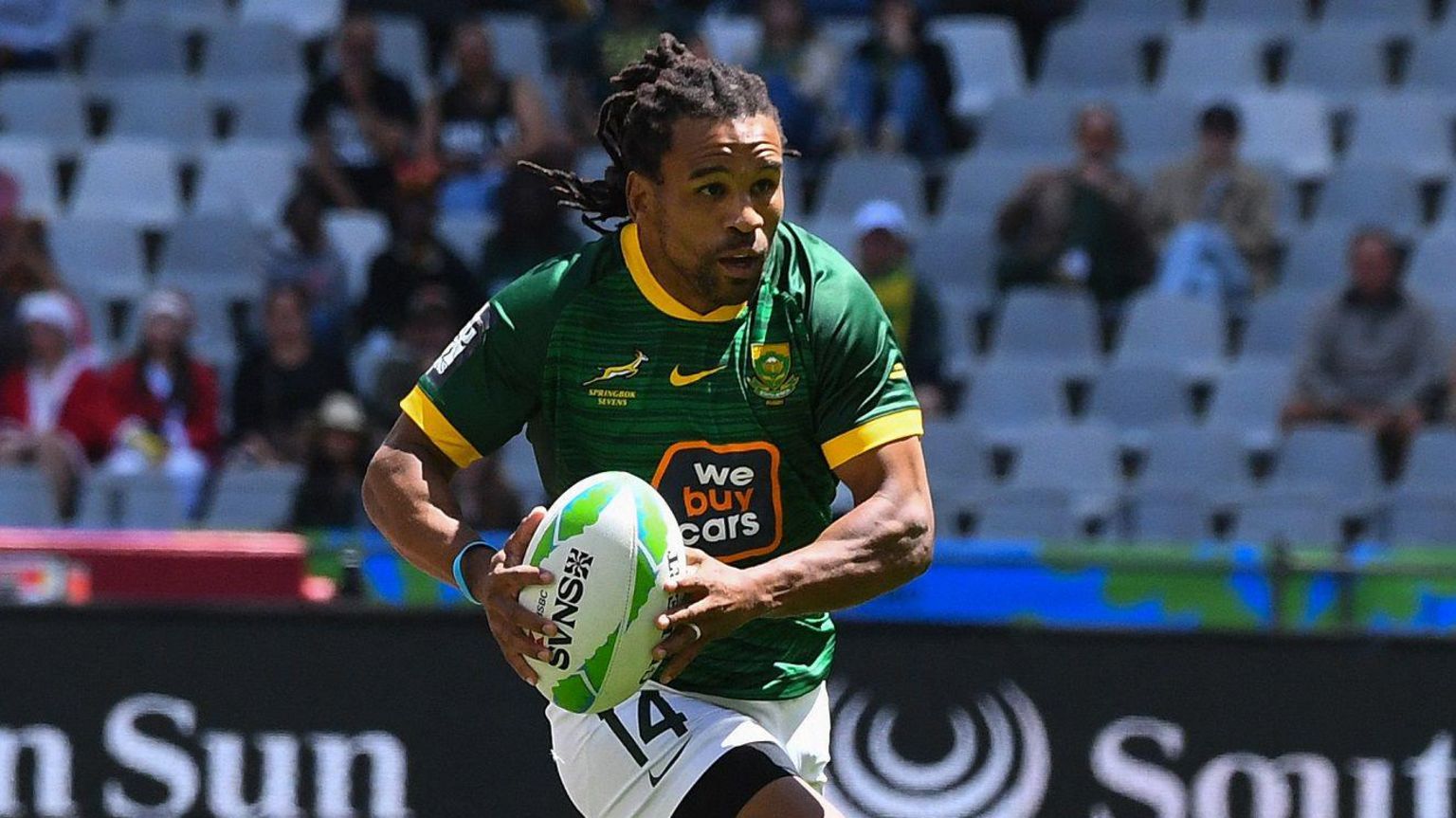 South Africa's Rosko Specman carries the ball forward during a rugby sevens game