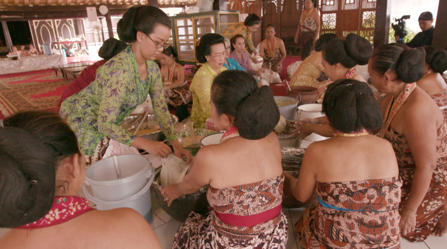 Women doing ceremonial cooking of sacred cakes.