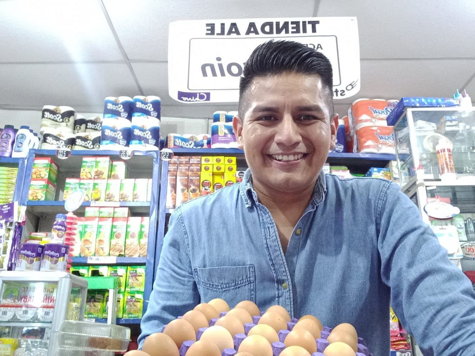 Ed Hernandez in his store holding eggs