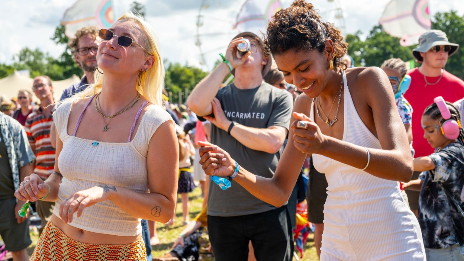 Two people smiling and dancing in a crowd at the festival