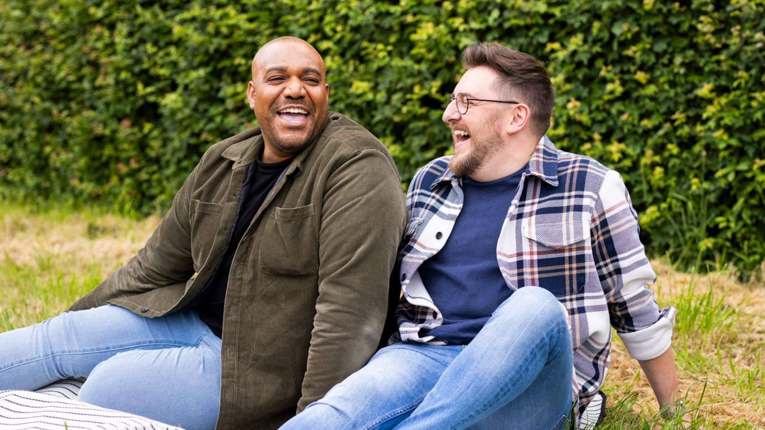 Miles Asteri and his husband Pip Asteri sitting on grass