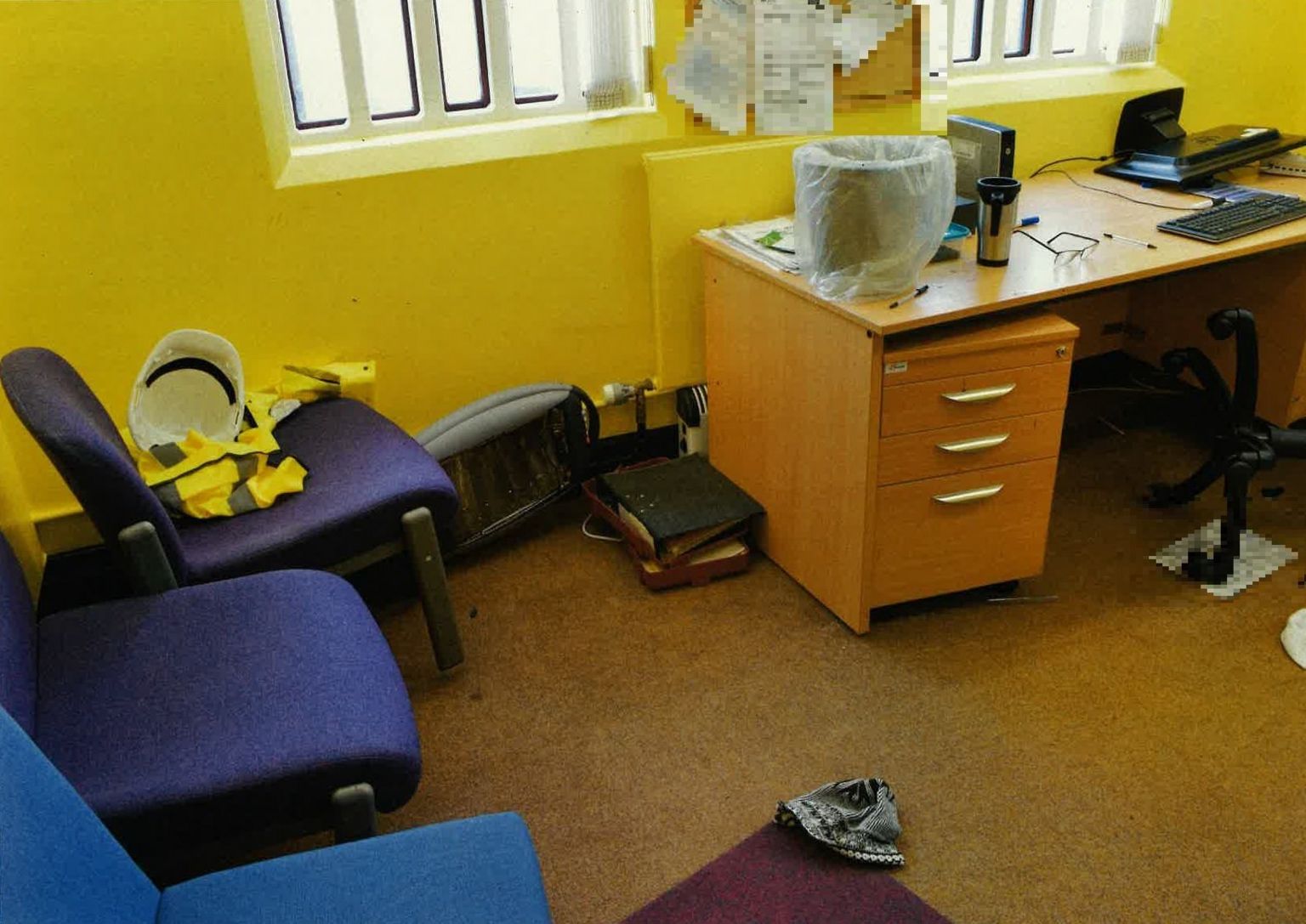 Office where attack took place showing debris and chairs upturned.