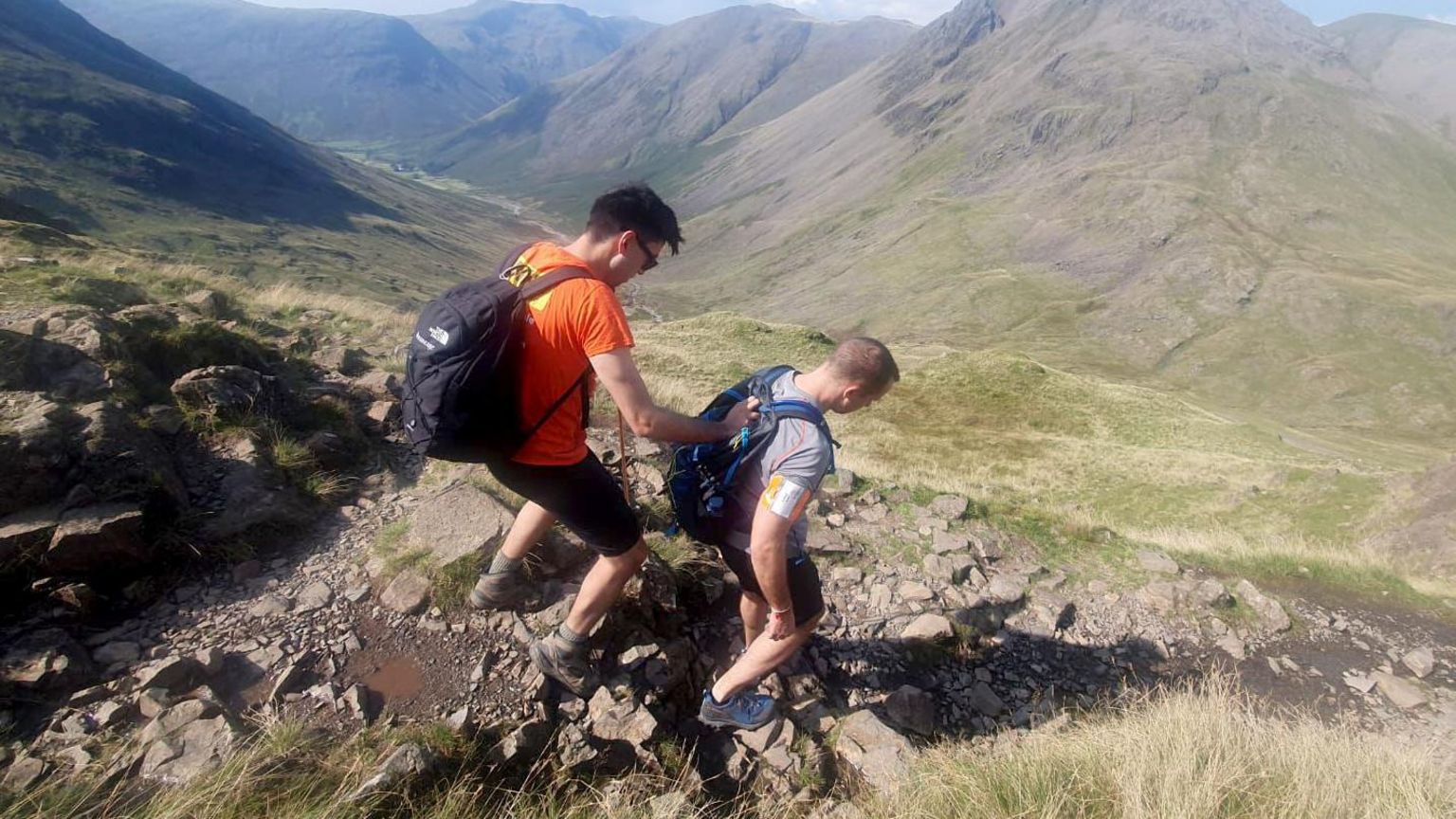 Michael Smith holding on to boss Jack Stacey as he is guided down a hill 
