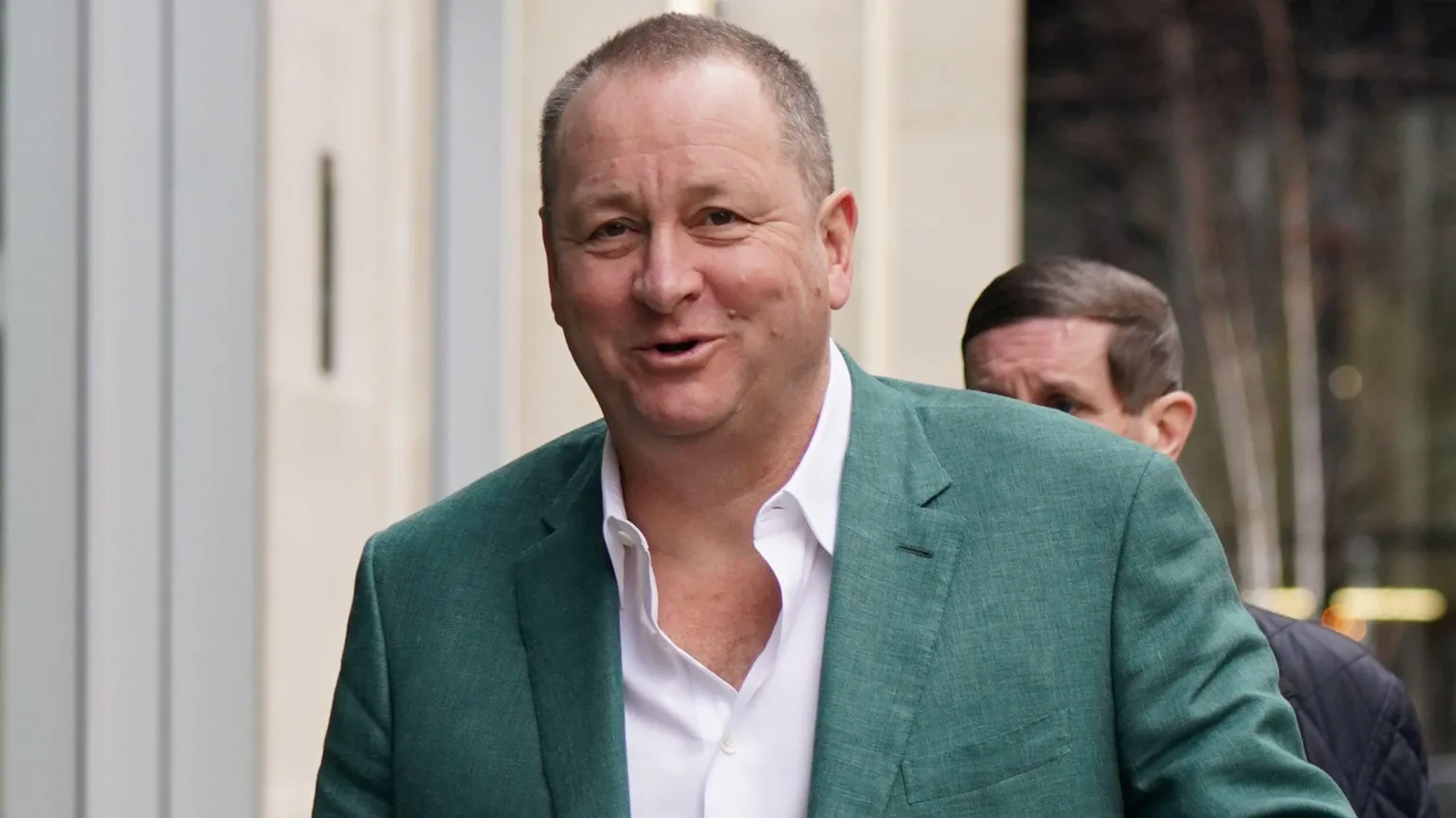 PA Media  Mike Ashley wearing a green jacket 