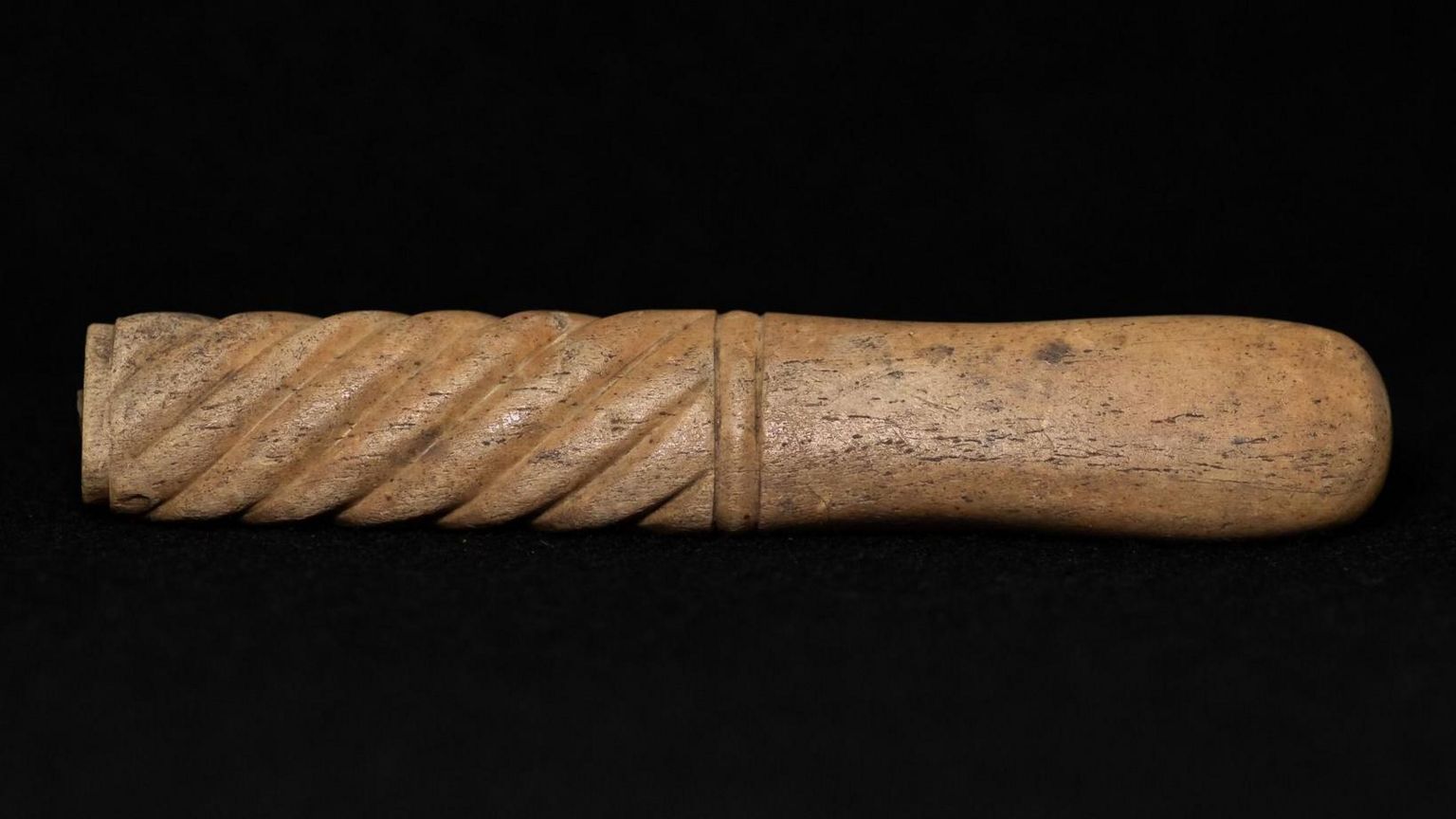 Wooden knife handle with a spiral pattern on one half