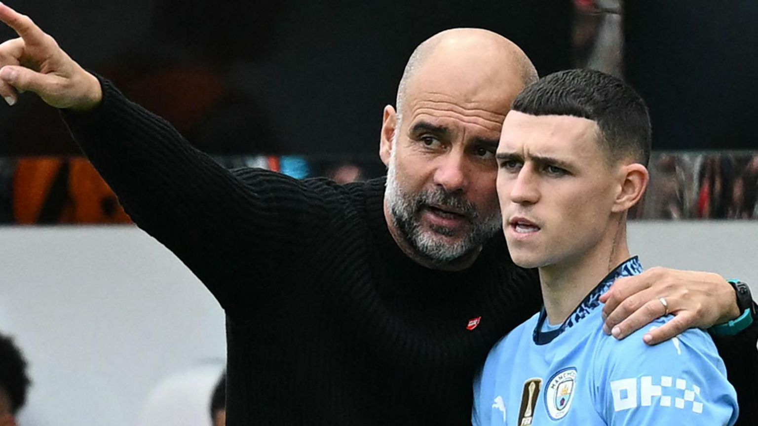 Pep Guardiola and Phil Foden in discussion