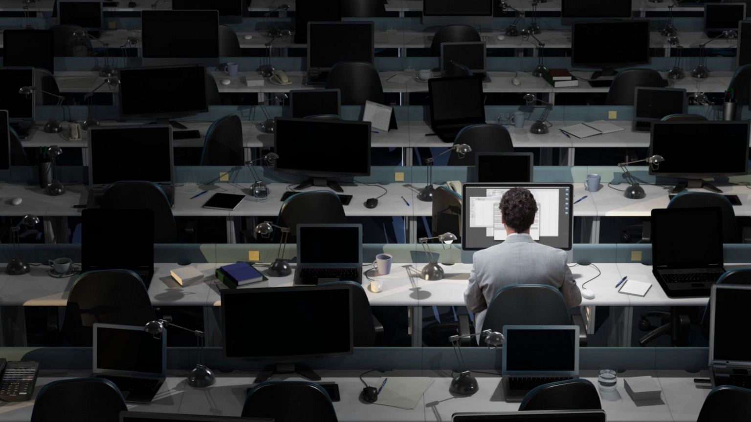 Man at workstation alone - stock image