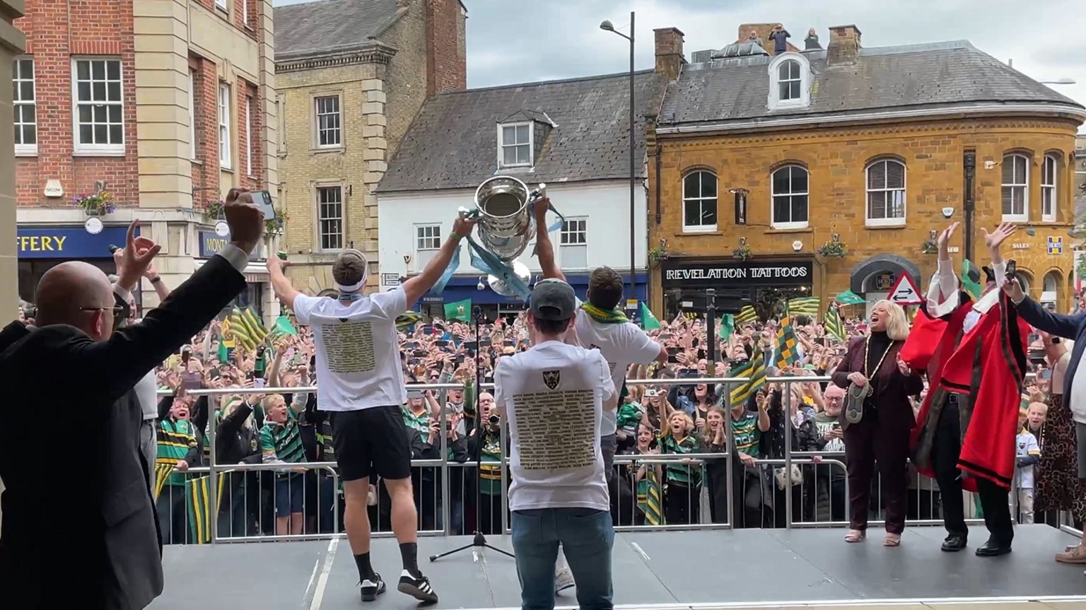 Saints players lift the Premiership trophy to the fans in Northampton