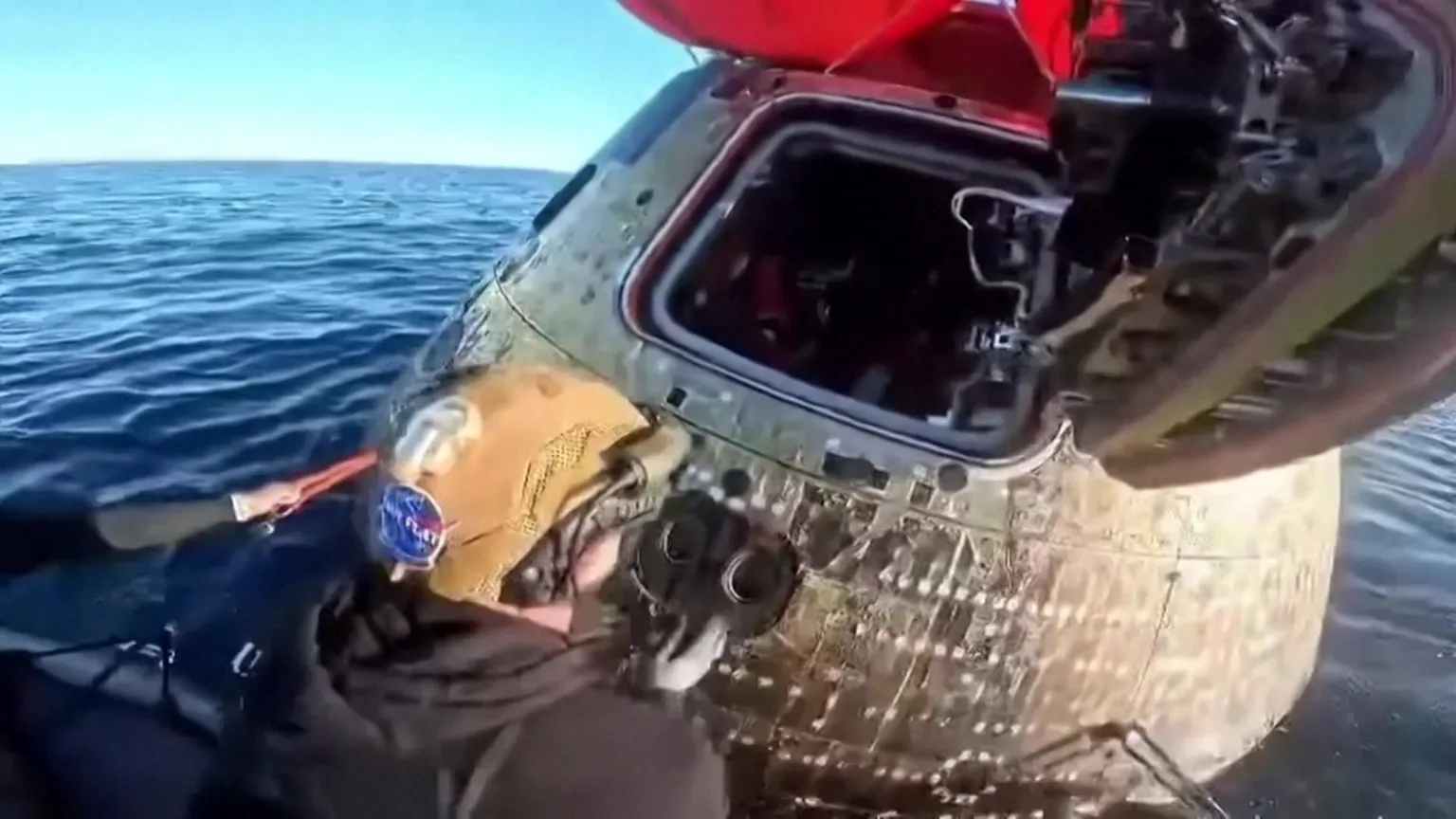 Orion capsule hatch door being opened