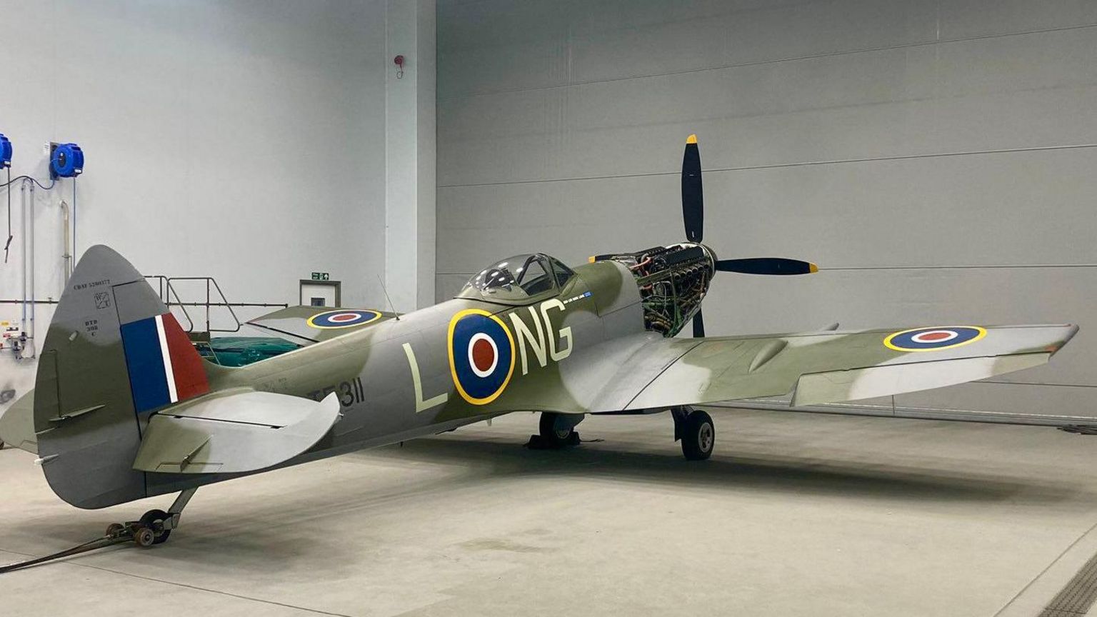 Spitfire TE311 facing a one o'clock position, with LONG painted on the fuselage  