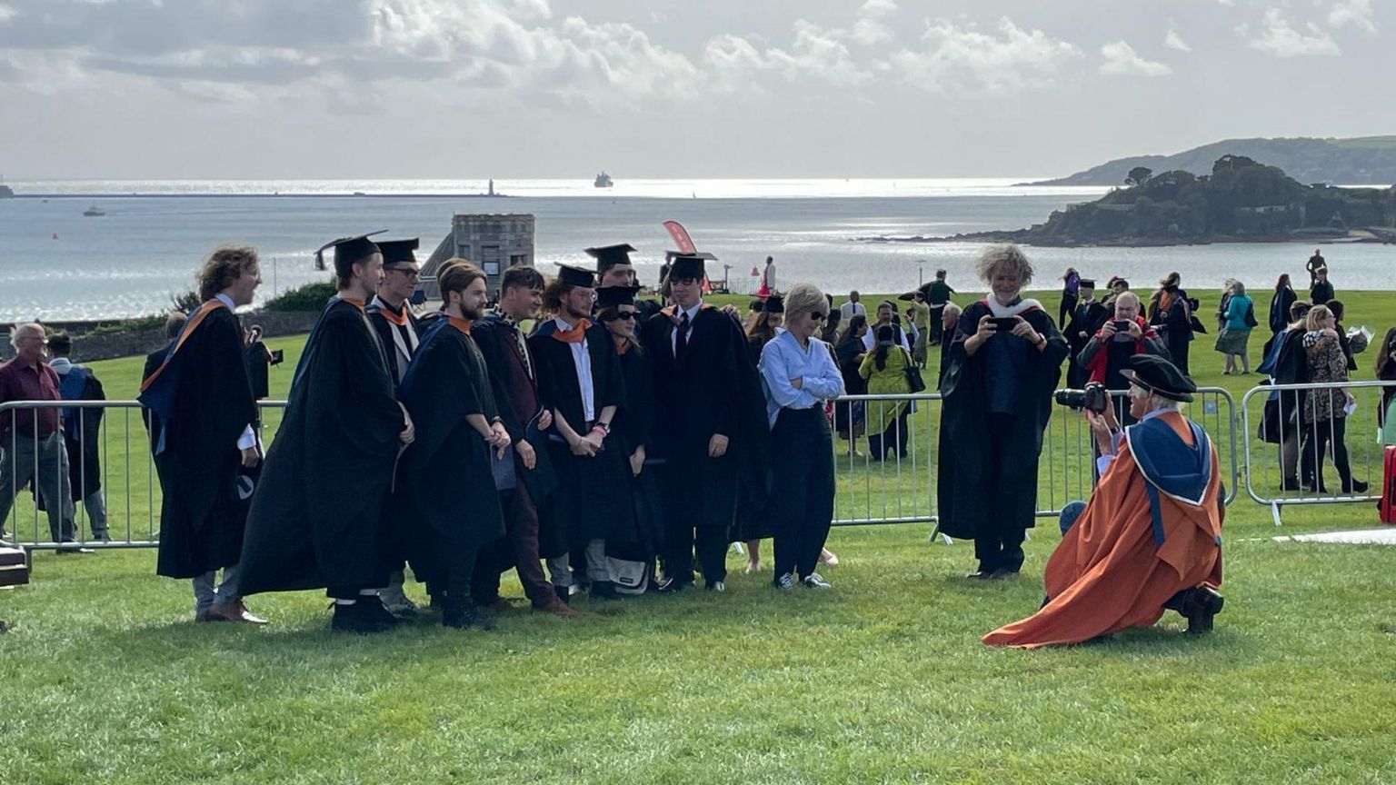 Sir Roger Deakins taking photos of graduates