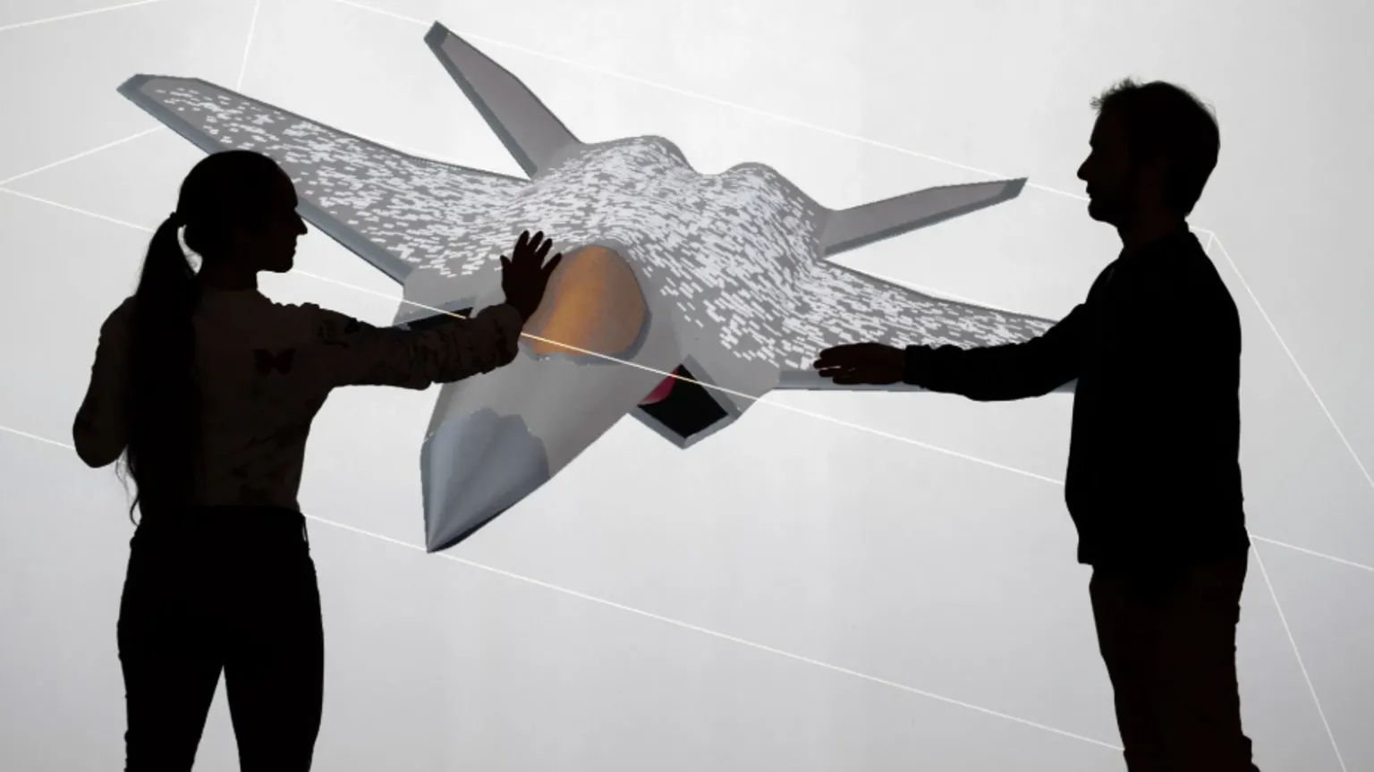 Dassault Aviation A man and woman touch a mock-up of a plane