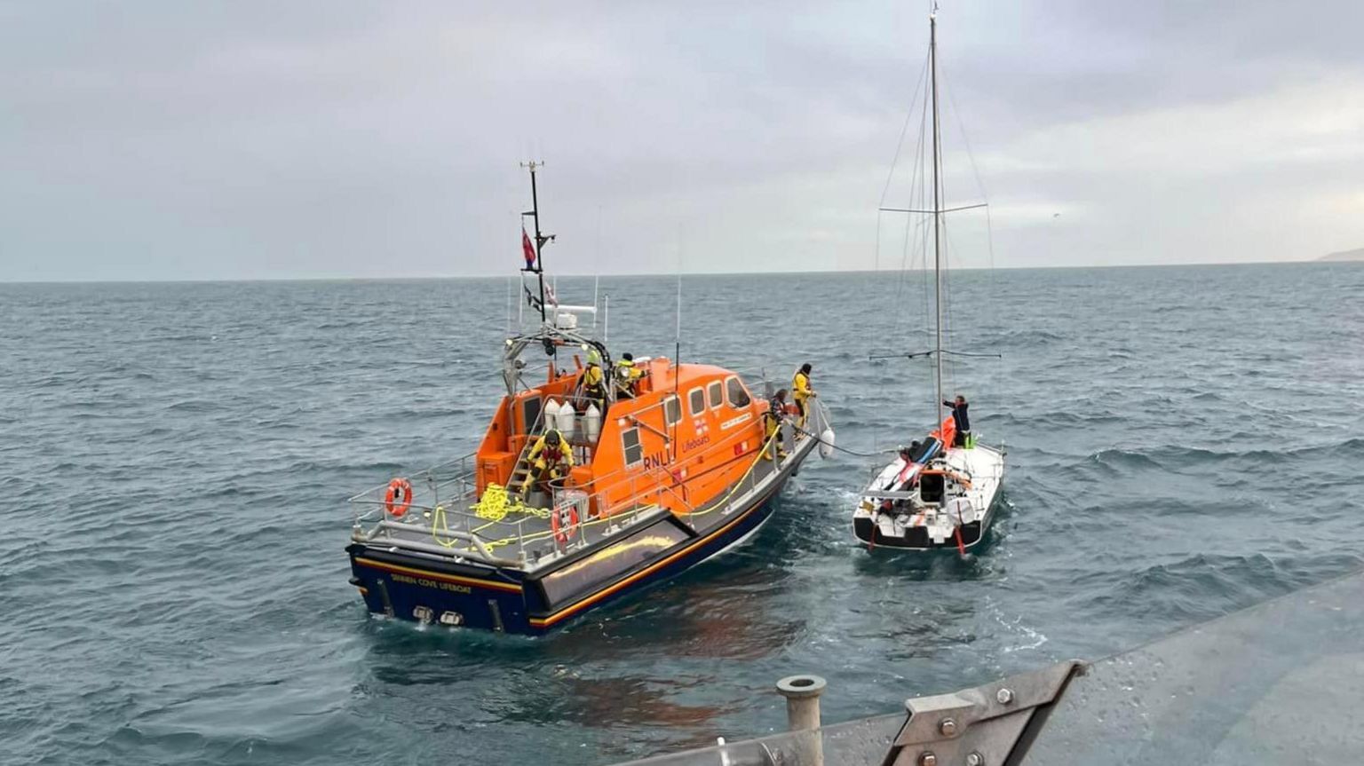 The Sennen Cove lifeboat at sea with the yacht