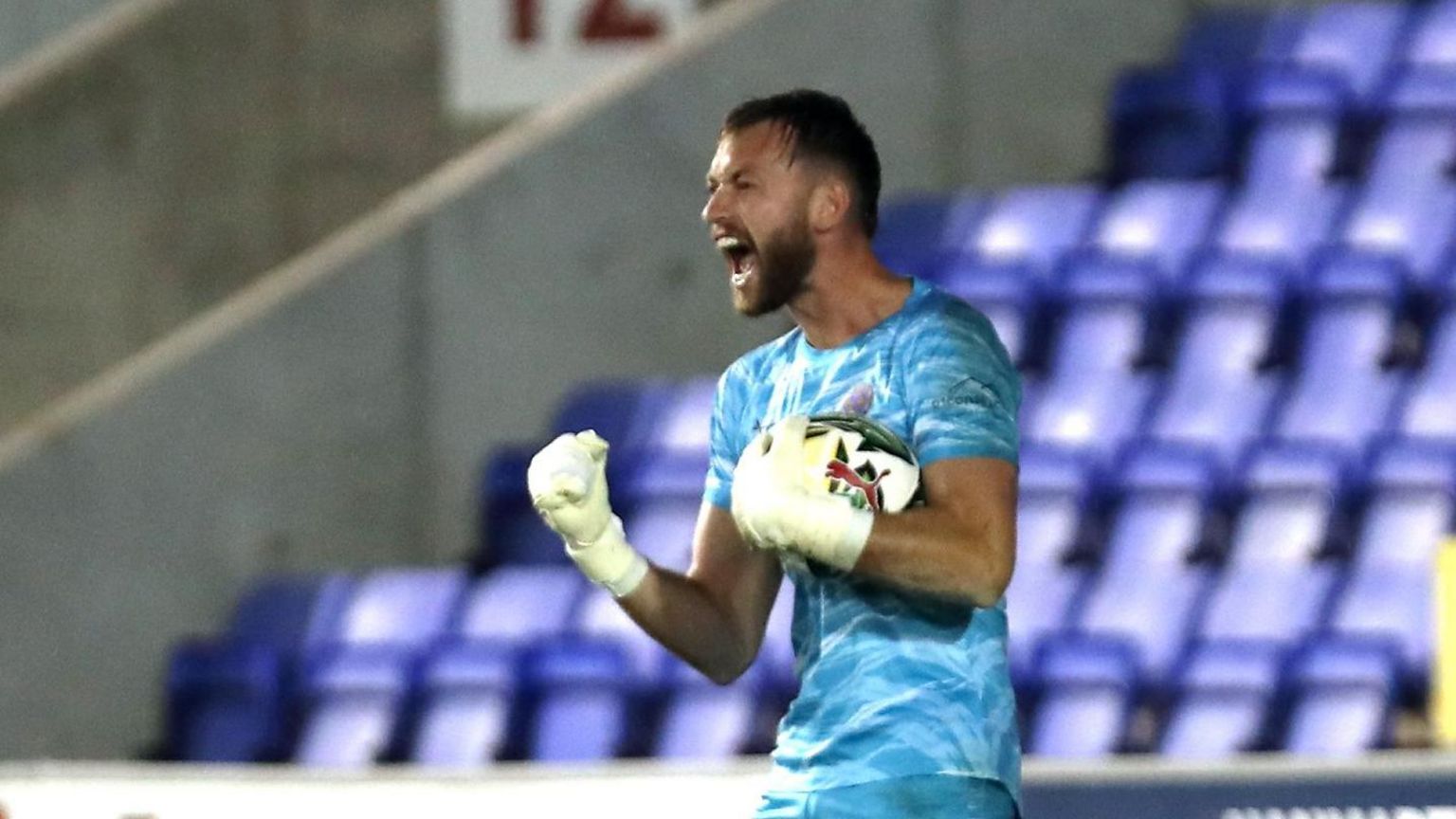 Shrewsbury keeper Toby Savin celebrates his decisive penalty save from Curtis Edwards in the shoot-out