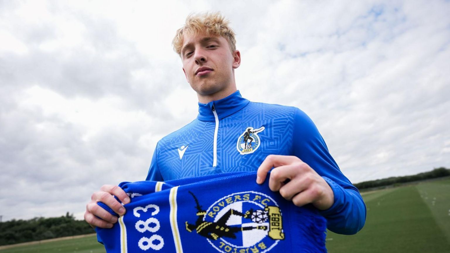 Dan Ellison holding a Bristol Rovers scarf