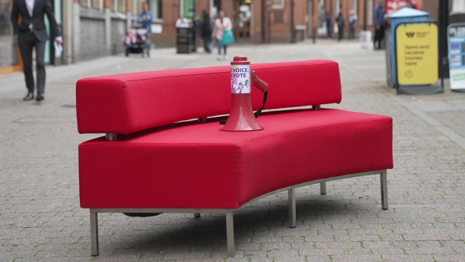 Red sofa with megaphone on it in Aldershot town centre