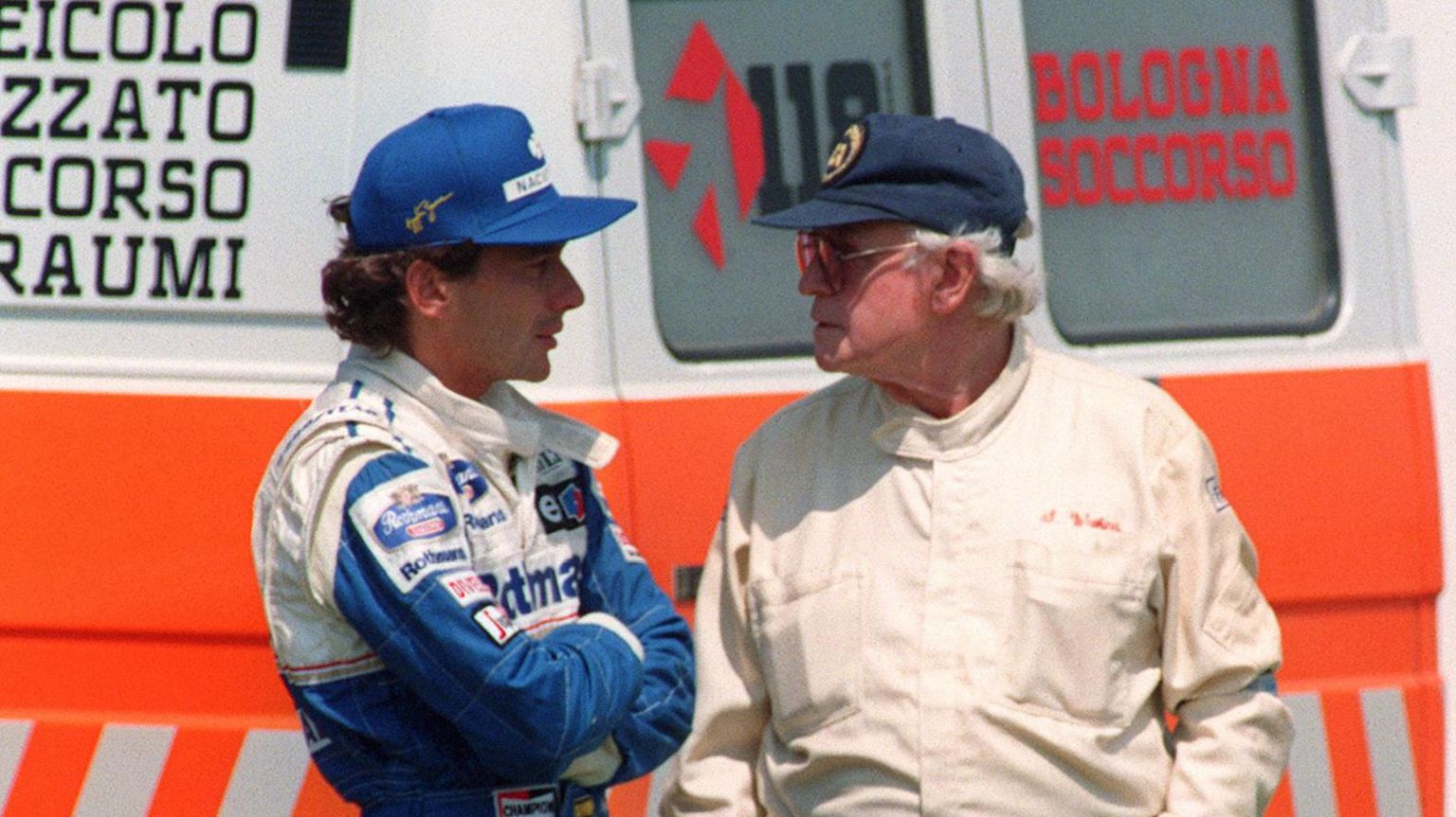 Aryton Senna and Sid Watkins in conversation in front of an ambulance at Imola