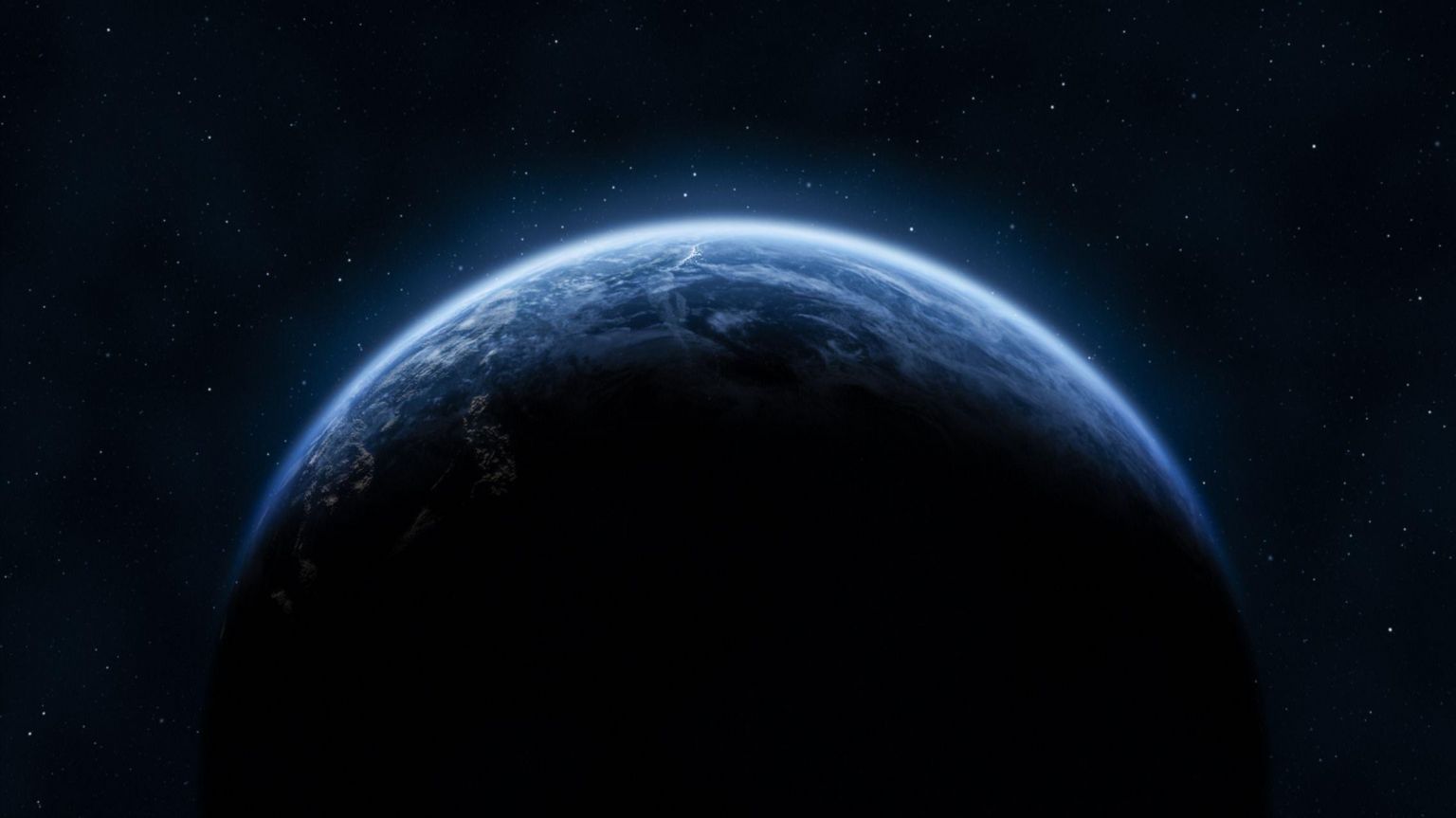 从太空看到的地球，行星边缘在繁星点点的背景下显得格外明亮。