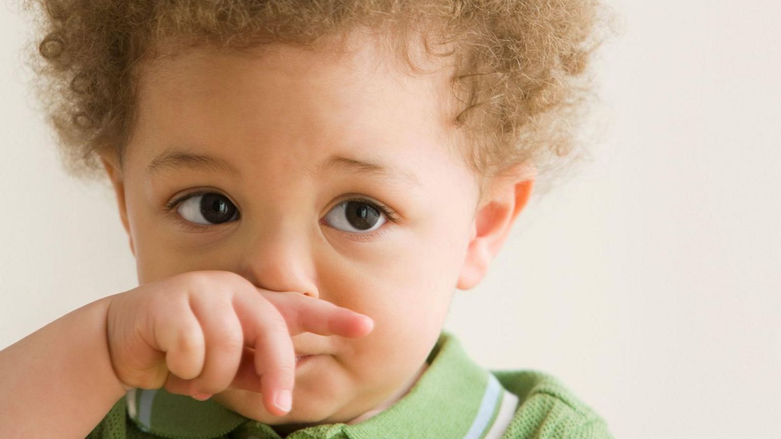 picture of young child wiping his nose 