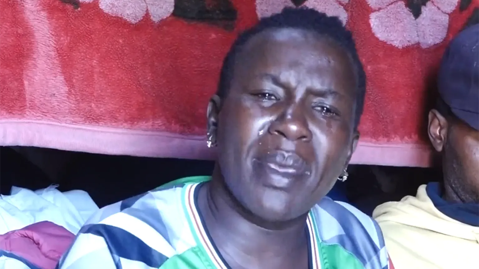 Eric Githui A head and shoulders image of Lucy Kagure, who is crying. She is wearing a sports top.