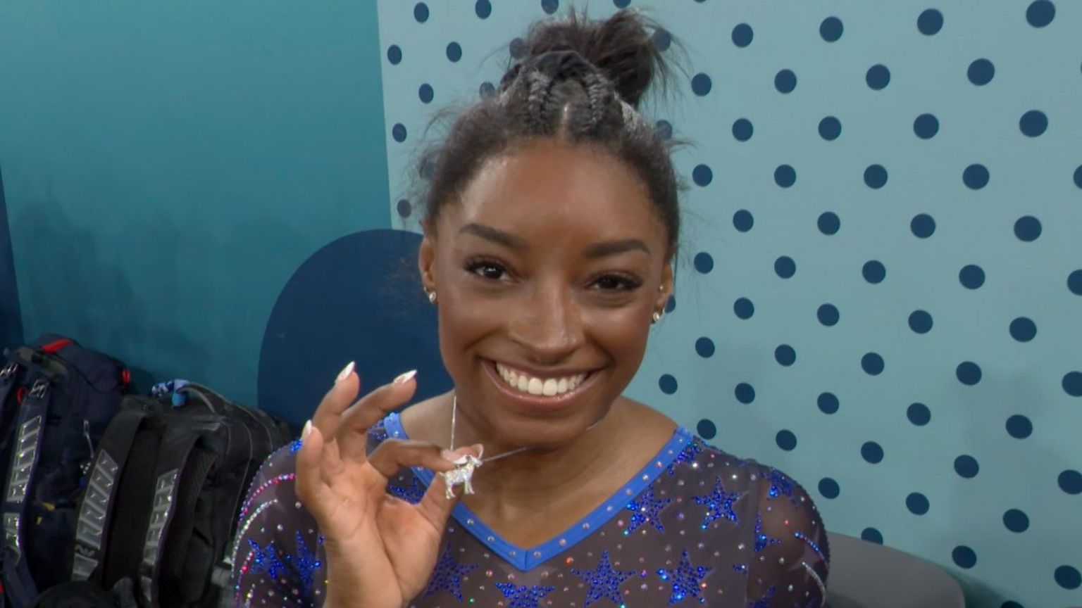 Simone Biles shows off her goat necklace