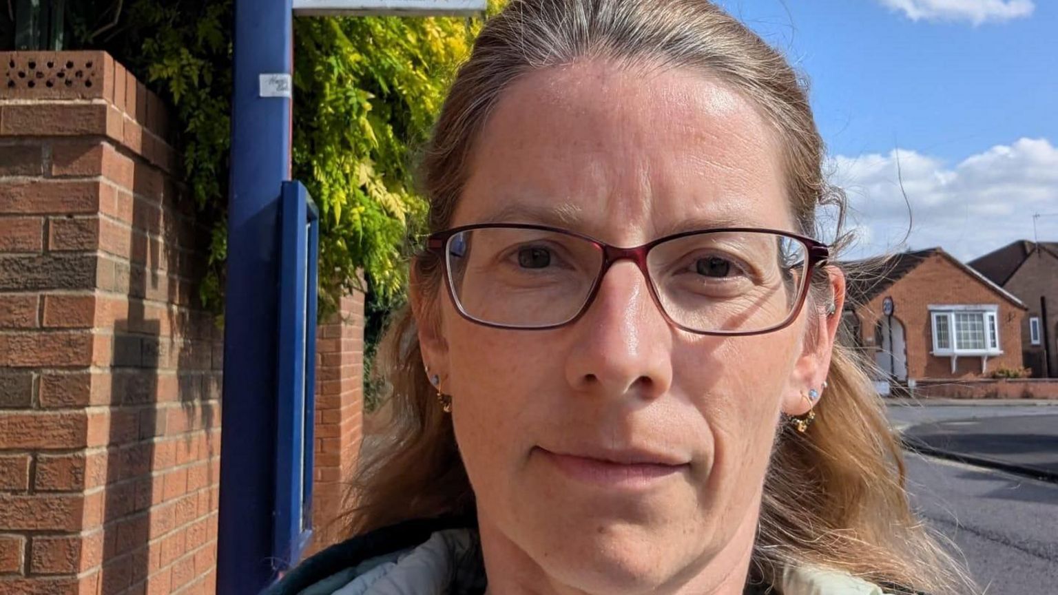 Christina Chinnian is pictured in front of a bus stop