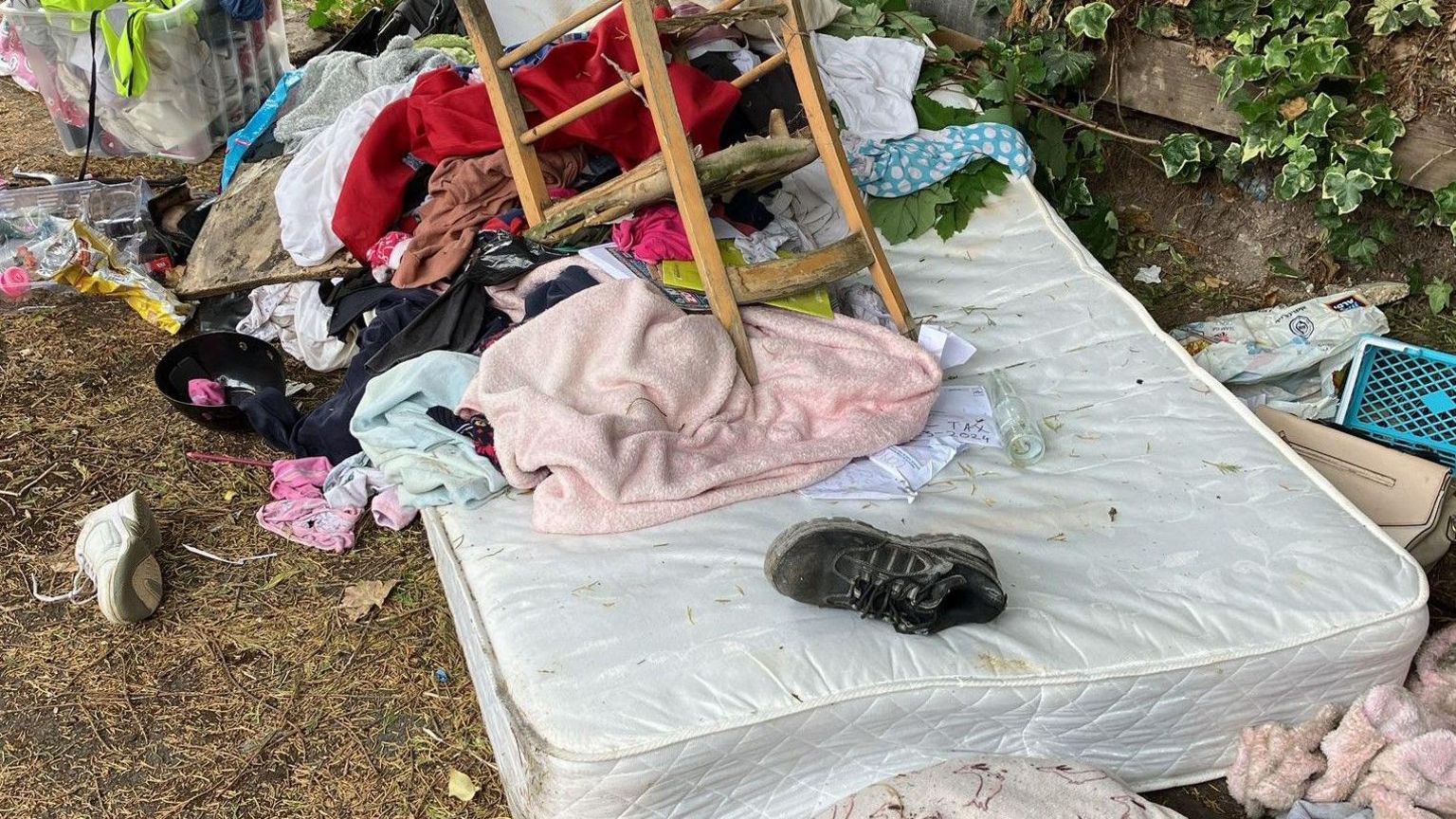 Waste dumped on a patch of land in Boston, including a silver-coloured mattress, a broken wooden chair, worn trainers and assorted clothes.