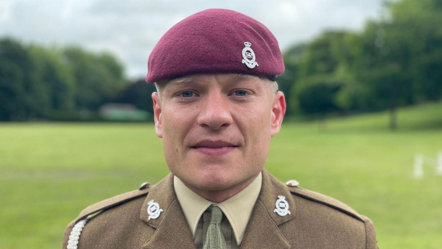 Sam Hayes with purple army beret and brown and green ceremonial uniform